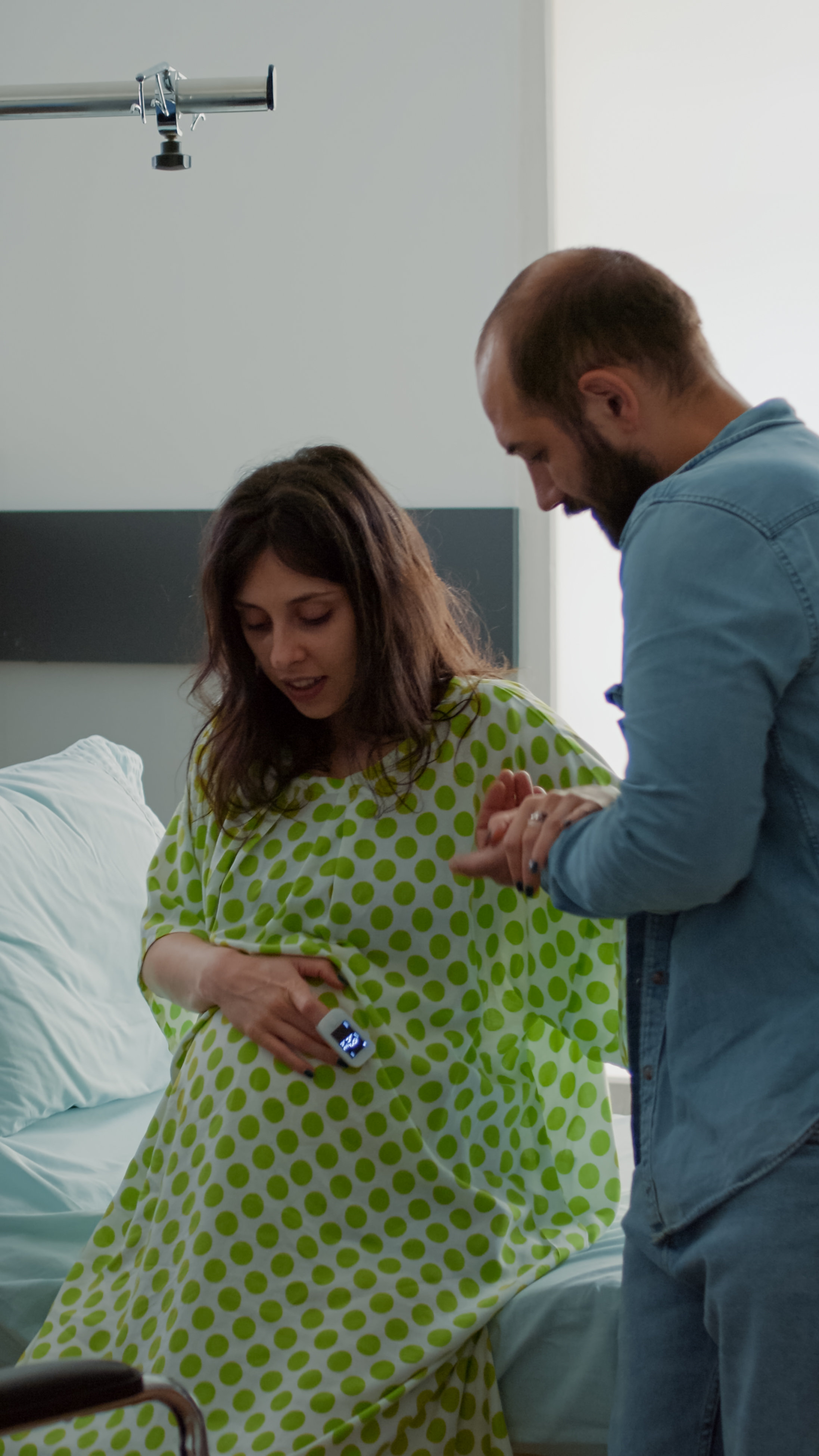 african-american-nurse-helping-pregnant-wife-sit-wheelchair-maternity-ward-hospital-young-caucasian-mother-preparing-childbirth-medical-assistance-with-father-baby