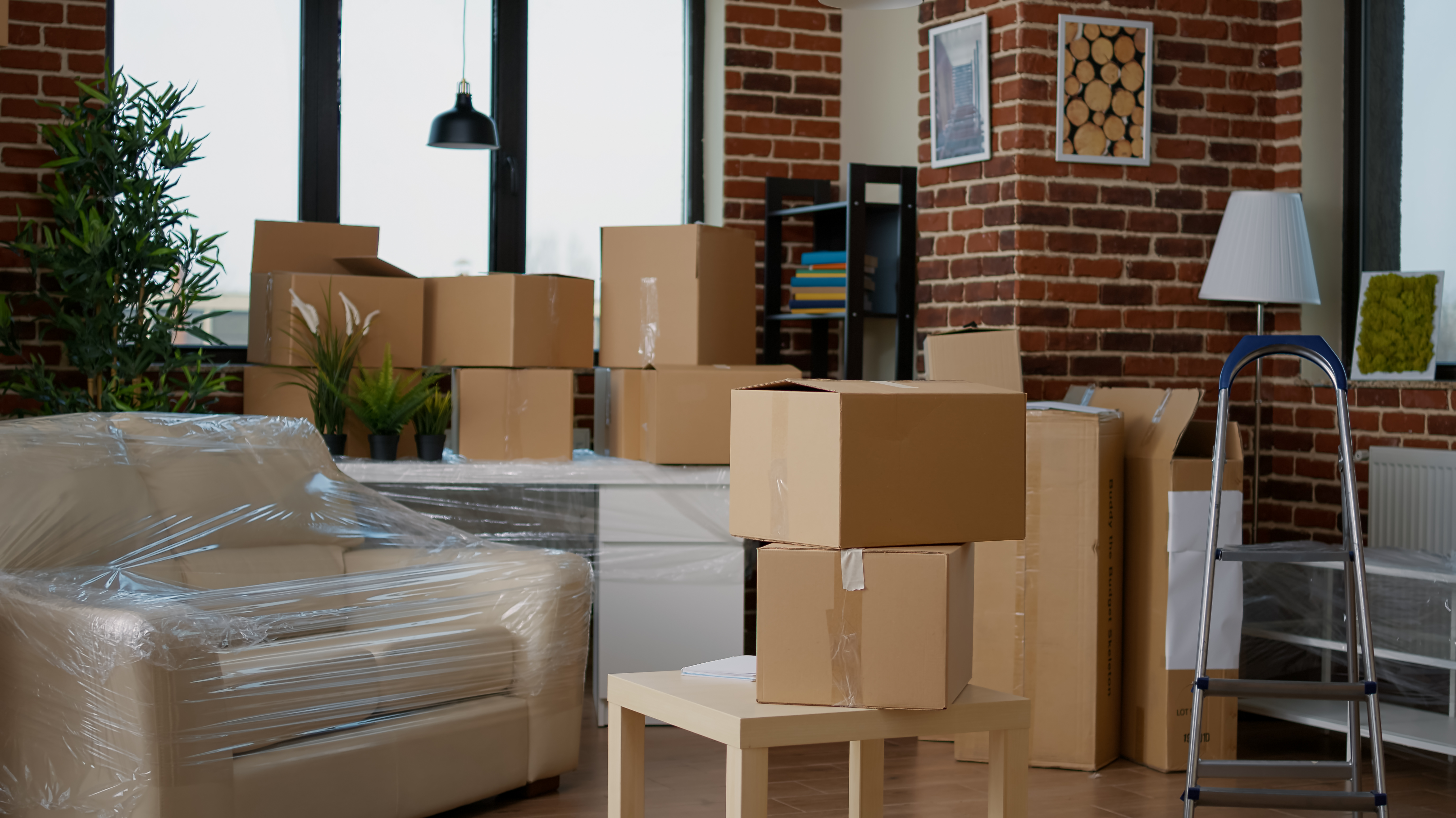 nobody-empty-living-room-with-cardboard-packaging-new-home-furniture-things-stack-carton-boxes-no-people-household-property-with-package-cargo-move-real-estate