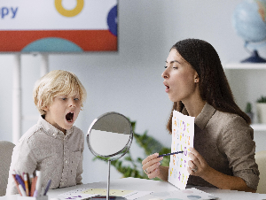 woman-doing-speech-therapy-with-little-boy-her-clinic